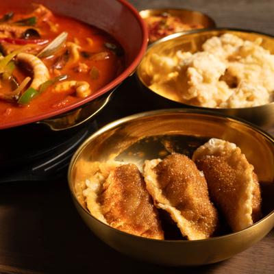 Combvo meal with seafood noodle soup, fried dumplings and steamed rice.
