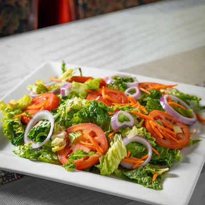 Salad with lettuce, tomato, onion, and carrots.