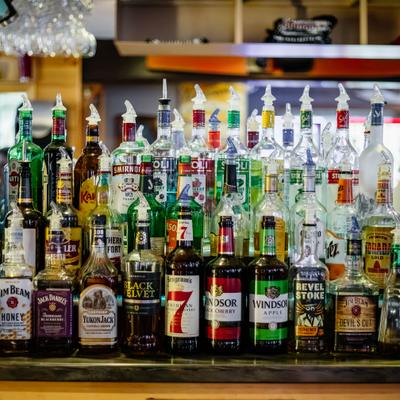 A back bar with various liquor bottles.