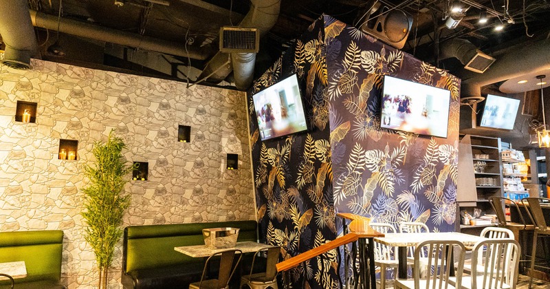 Seating area with decorated wall and TVs on it