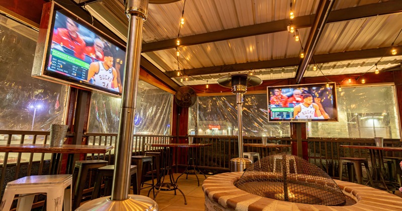 Covered patio area, TVs on the walls