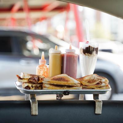tray with food hanging on car window.