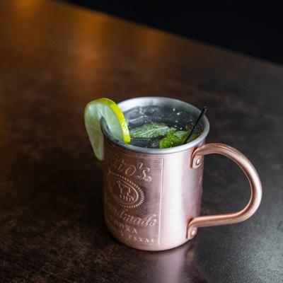Moscow Mule served in a copper mug and garnished with slice of lime and mint.