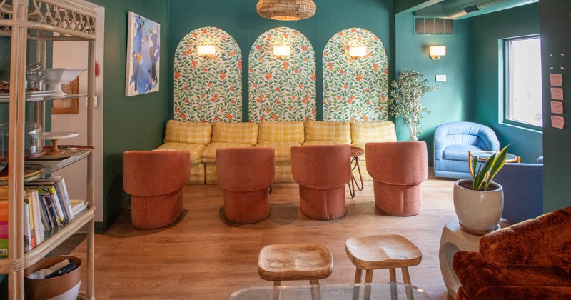 Interior, seating area, long comfy sofa with armchairs and coffee tables