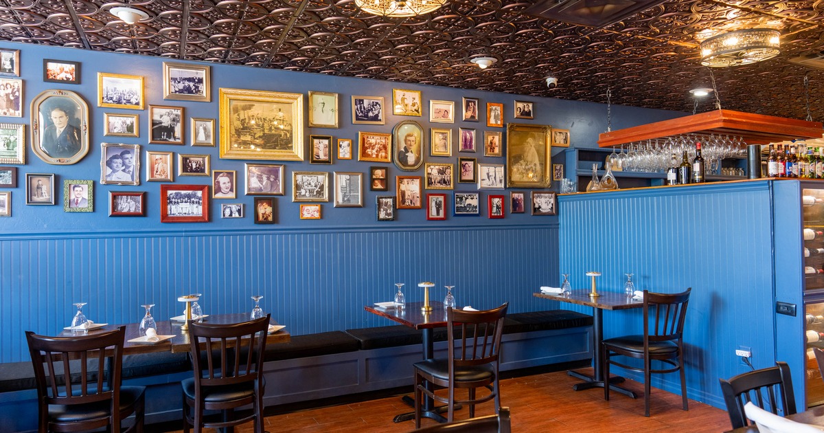 Interior with blue walls, vintage photos and wooden furniture.
