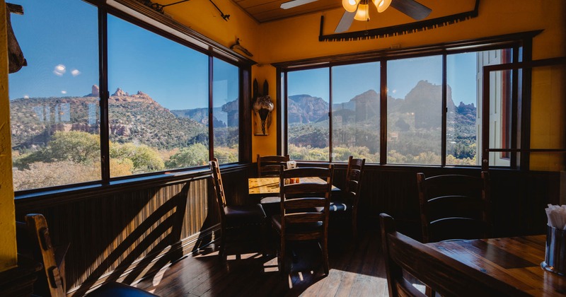 Interior, tables, chairs, windows with a wide view of the mountains and the prairie