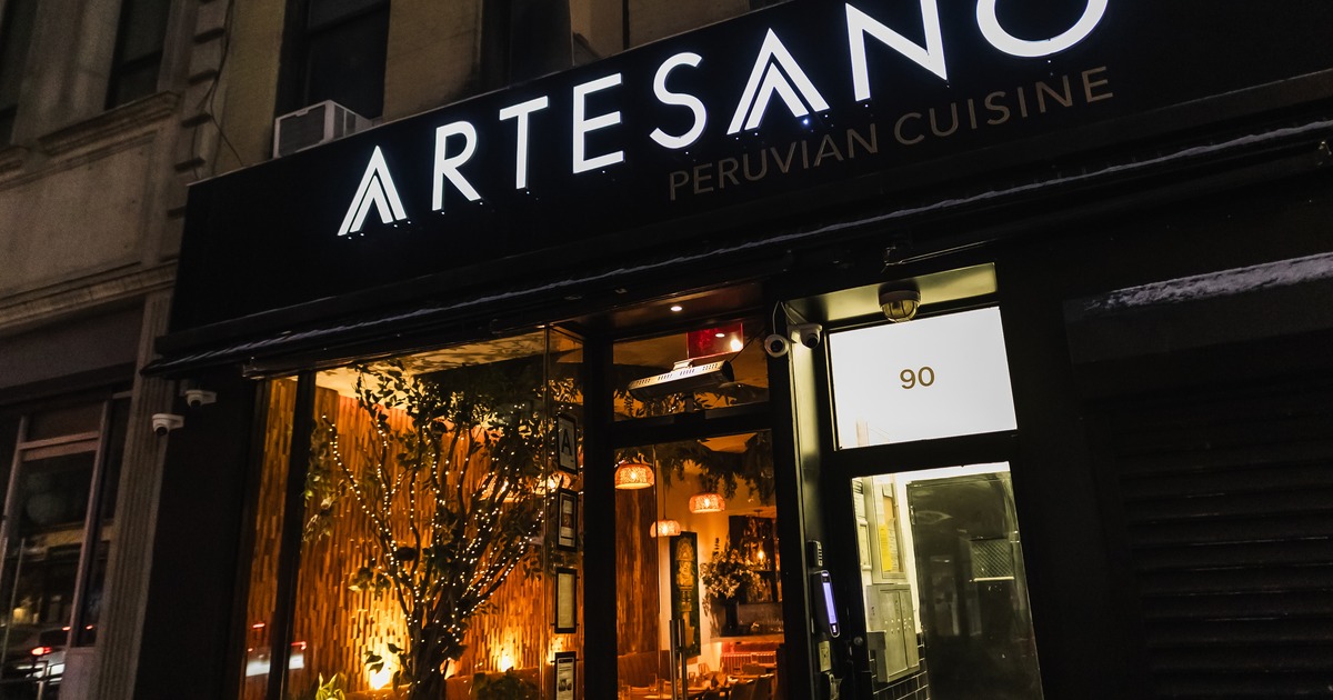 Exterior, front of restaurant, entrance, light sign above, night view
