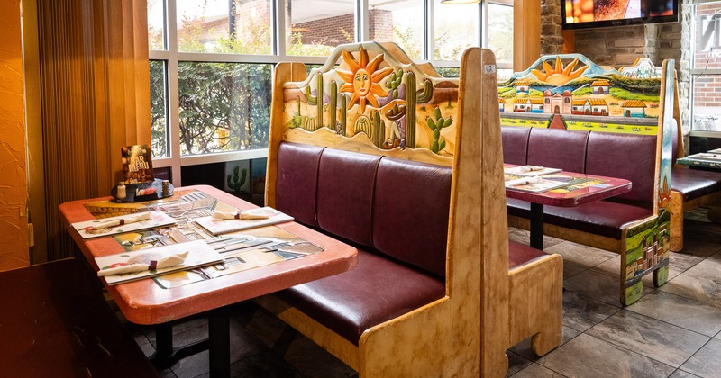 Mexican-style interior dining area, dining booths with set tables ready for guests