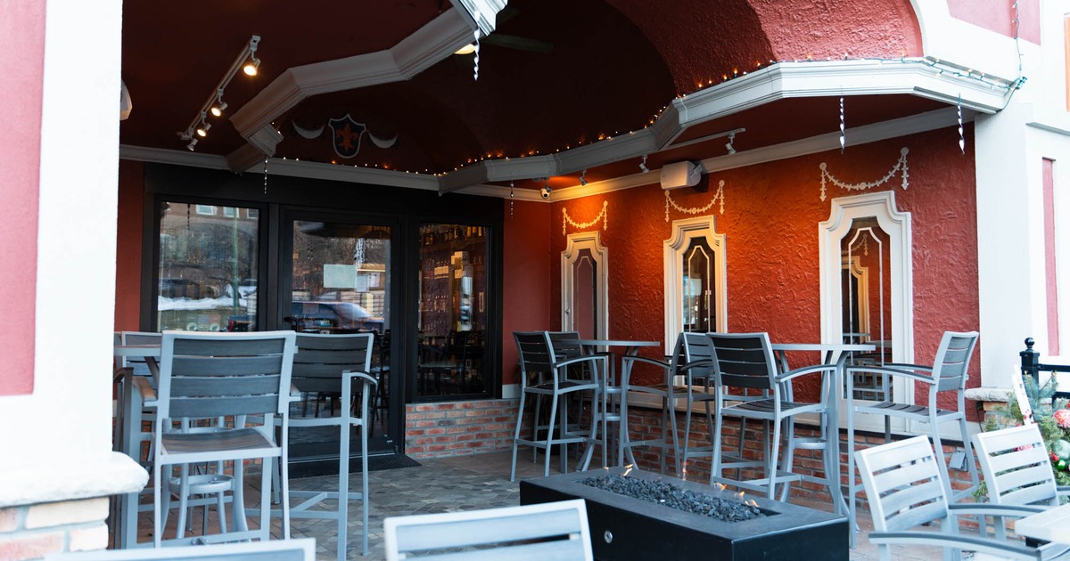 Exterior, patio, high seating tables with stools, restaurant entrance