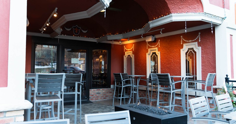 Exterior, patio, high seating tables with stools, restaurant entrance