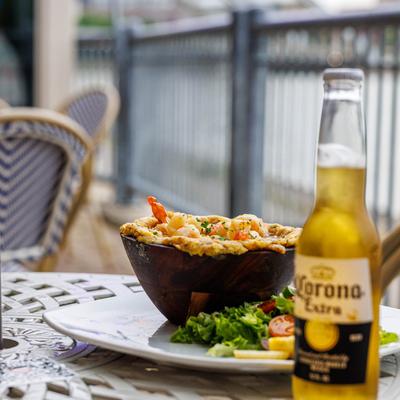 Shrimp and lobster-stuffed mofongo with a side salad and a bottle of Mexican beer.