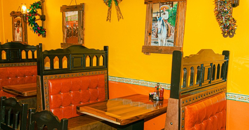 Interior, red leather seating booth, framed pictures on the wall