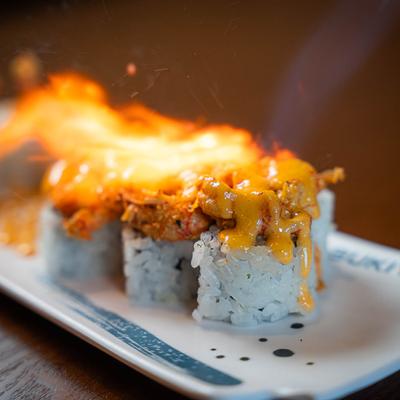 Flaming the Lobster volcano roll, close up.