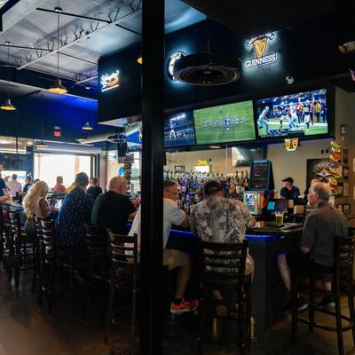 People watching a football game in a sports bar.
