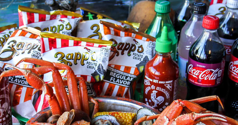 Seafood platter with beverages and chips on table
