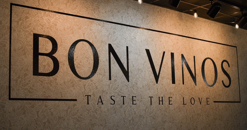Interior, a writing on a wall reading Bon Vinos Taste The Love