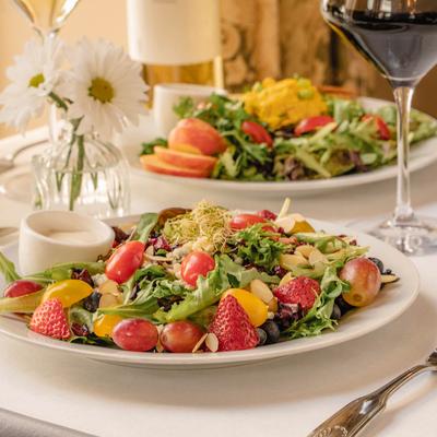 Summer Salad, with spring mix, apples. dried cranberries, cheese, toasted almonds, and dressing.