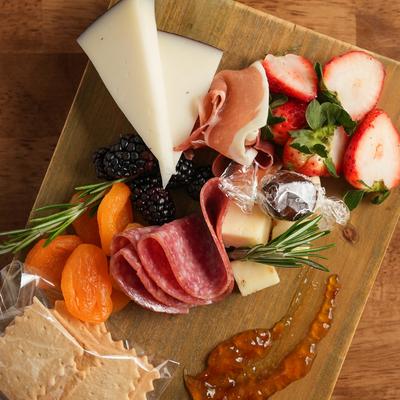 A single board meal with various foods for sampling.