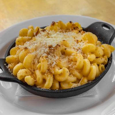 Baked macaroni topped with grated cheese.