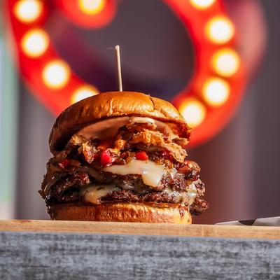 Cheeseburger, with pepper jack, red pepper relish, crispy onions, chipotle spread, and sriracha.