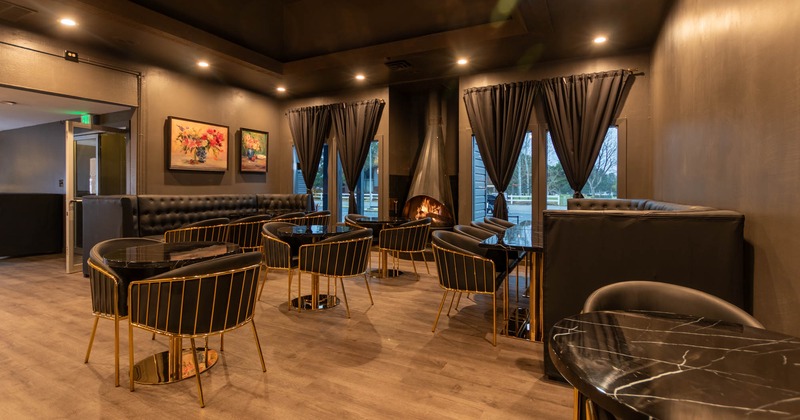 Inside, tables, chairs, long banquette seating