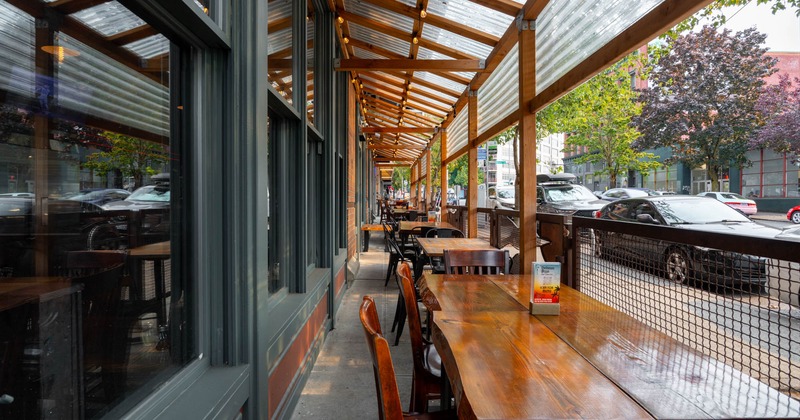 Exterior, covered patio, seating area, restaurant front, wooden top tables with chairs