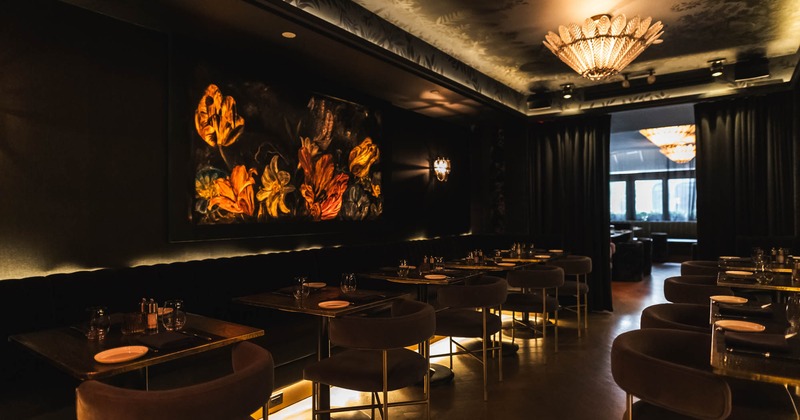 Interior, seating area, banquette bench with tables and chairs, subtle lighting