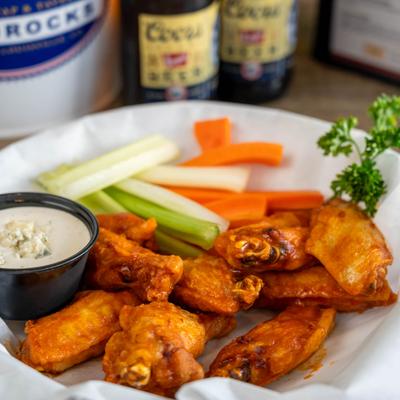 Traditional Bone-In Wings served with vegetable sticks and a dipping sauce.