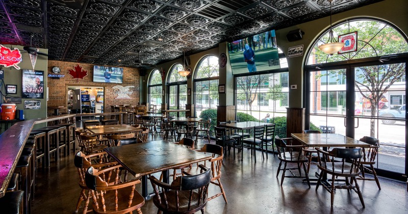 Interior, tables and chairs, TVs on the walls