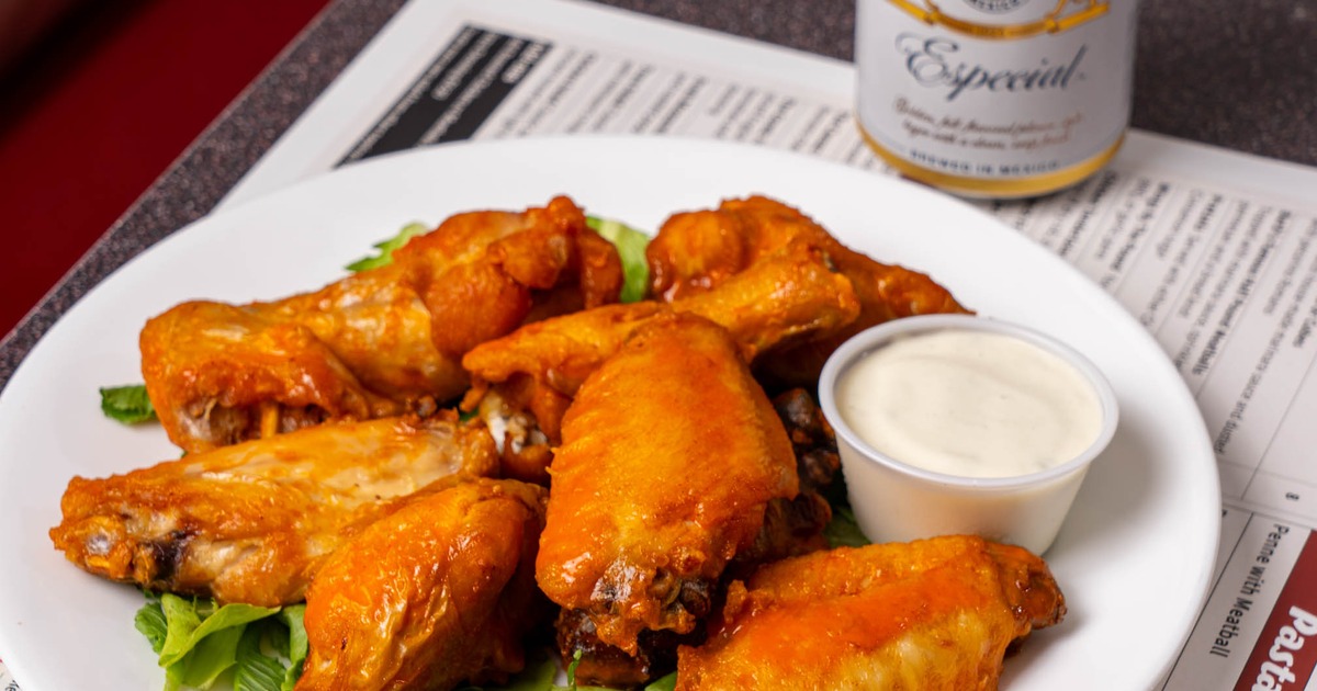Wings by the pound served with dipping sauce and a canned beer