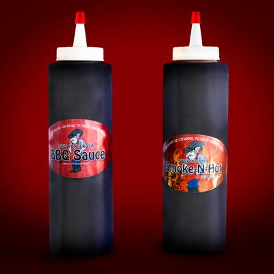 A bottle of BBQ sauce and Smoke-N-Hot BBQ sauce, isolated on a red background.