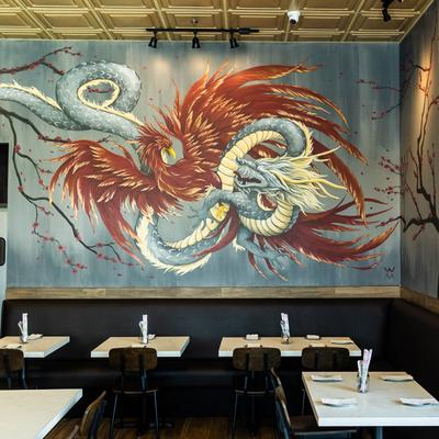 Interior, dining area decorated with a large mural on a wall
