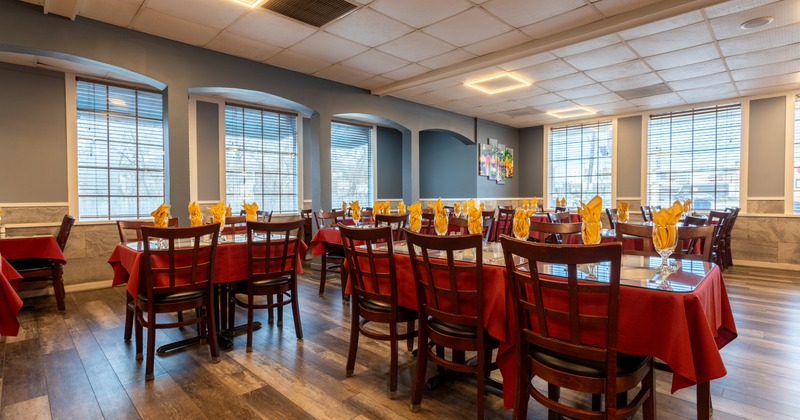 Interior, large dining area with wooden tables and chairs