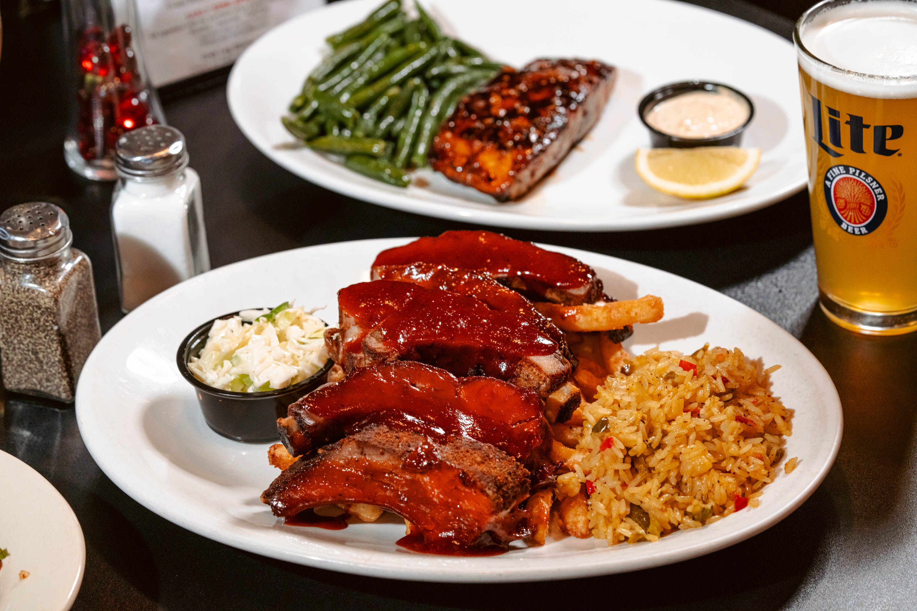 Ribs covered in our homemade BBQ sauce, served with rice and coleslaw
