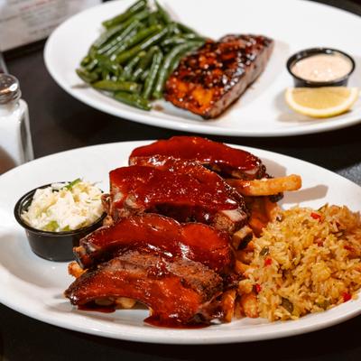 Ribs covered in our homemade BBQ sauce, served with rice and coleslaw.