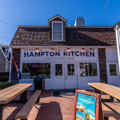 Exterior with signage and picnic tables.