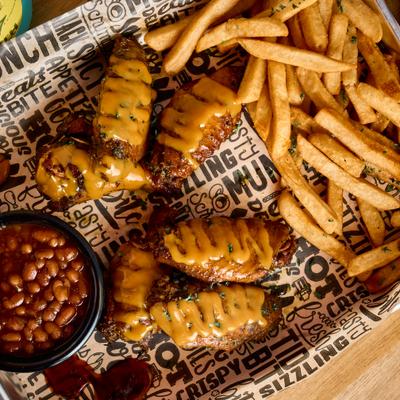 Gold Sauce Wings with sides of baked beans and french fries.