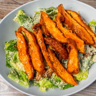 Salad with buffalo chicken and lettuce.