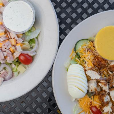 Chefs Salad served alongside Cobb Salad with chicken, close-up.