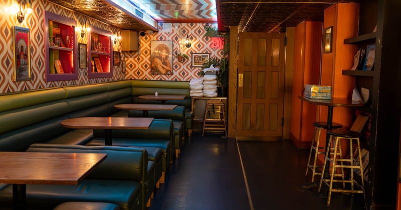 Interior, seating booths with tables, 70s  wallpapers, posters, high table with bar stools