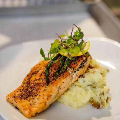 Grilled salmon fillet, on a bed of mashed potatoes.