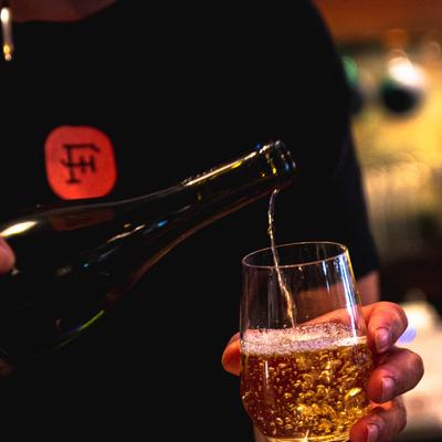 Bartender pouring a drink in a glass
