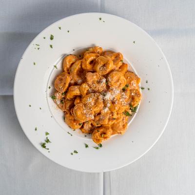 Tortellini pasta in pink cream sauce.