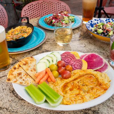 Hummus with vegetables and pita chips.