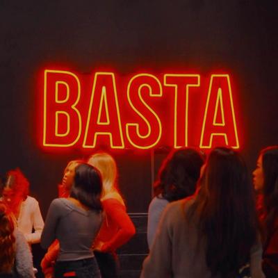 Crowd gathered in front of a BASTA neon sign.