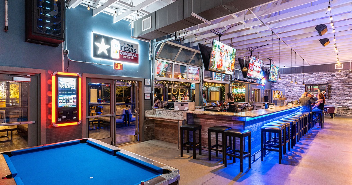 Interior, pool table and a bar with seating