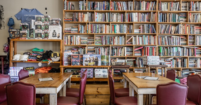 Diner tables and chairs in front bookshelves