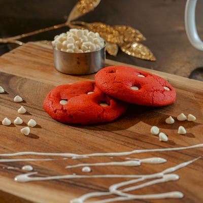 Two red velvet cookies with cream cheese chips.