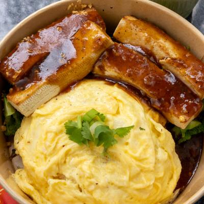 Glazed pork ribs with cabbage, garlic sauce, rice, and scrambled eggs.