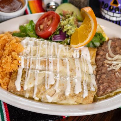 Green enchilada plate with rice, refried beans, and fresh salad.